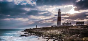 Dramatic sunset with iconic lighthouse on coast